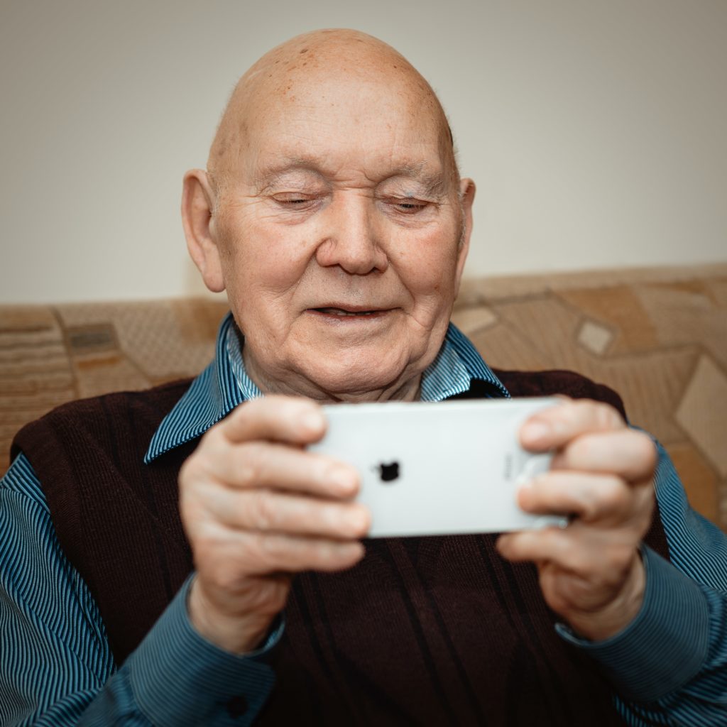 senior man on iphone